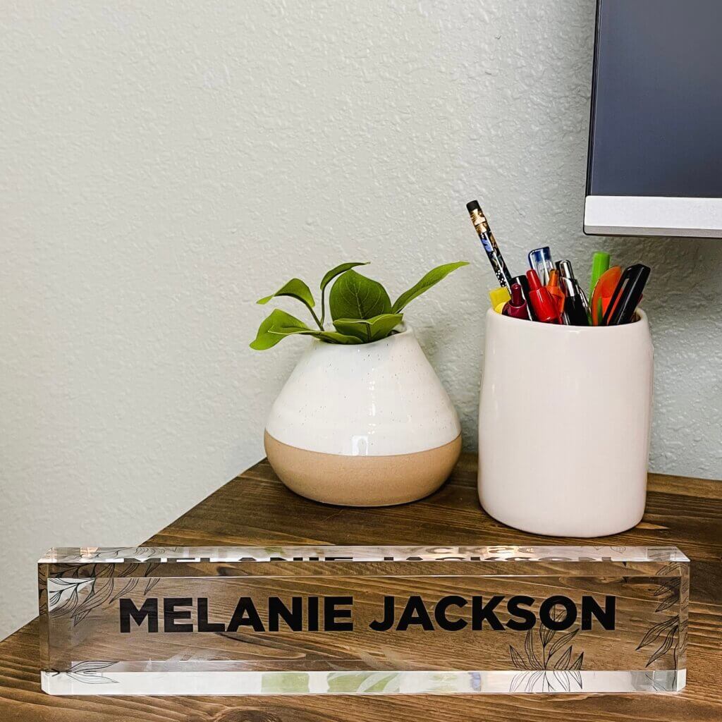 custom acrylic desk plate on a wooden desk