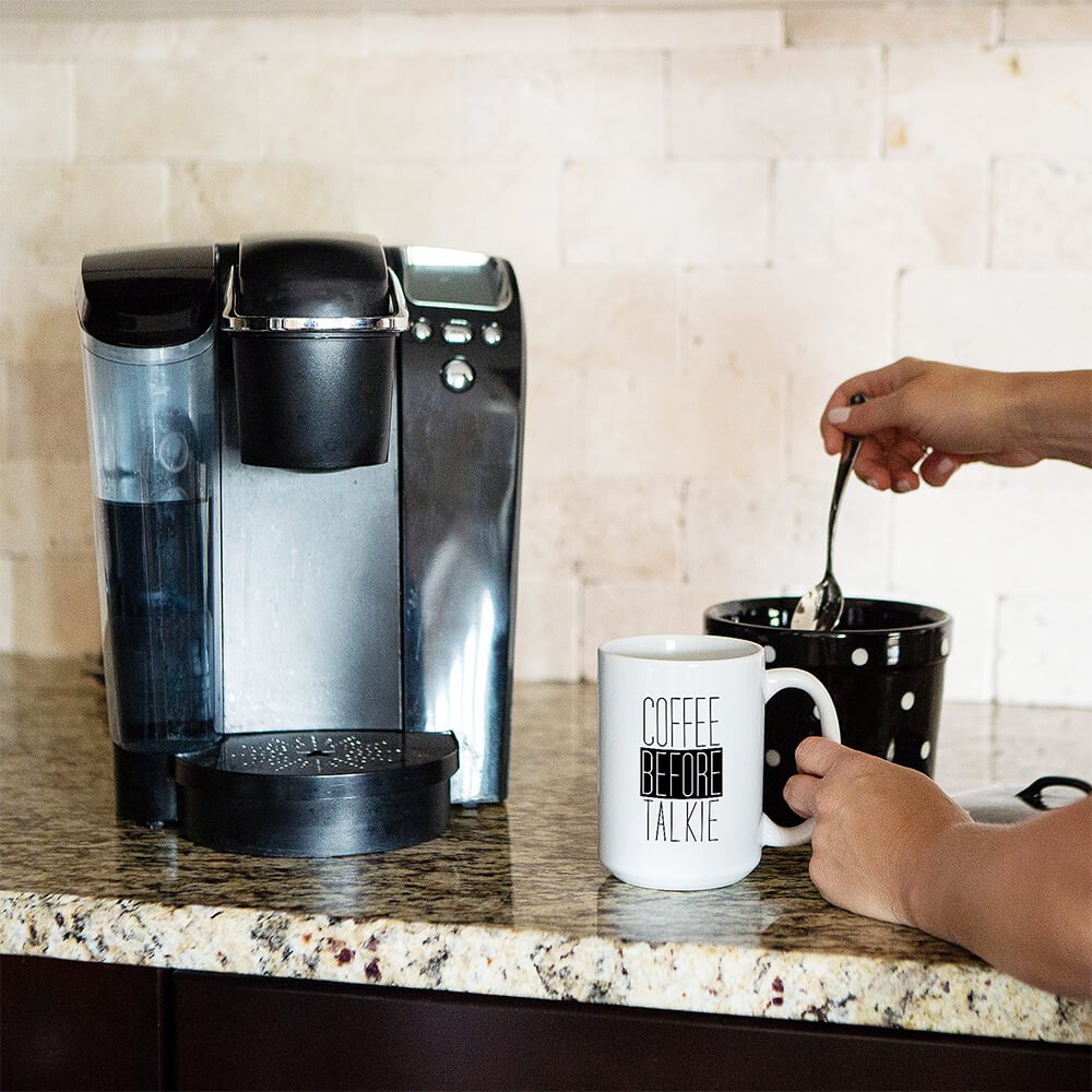 coffee machine next to a custom coffee mug