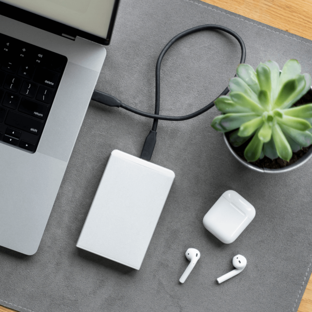 headphones and charger plugged into a laptop