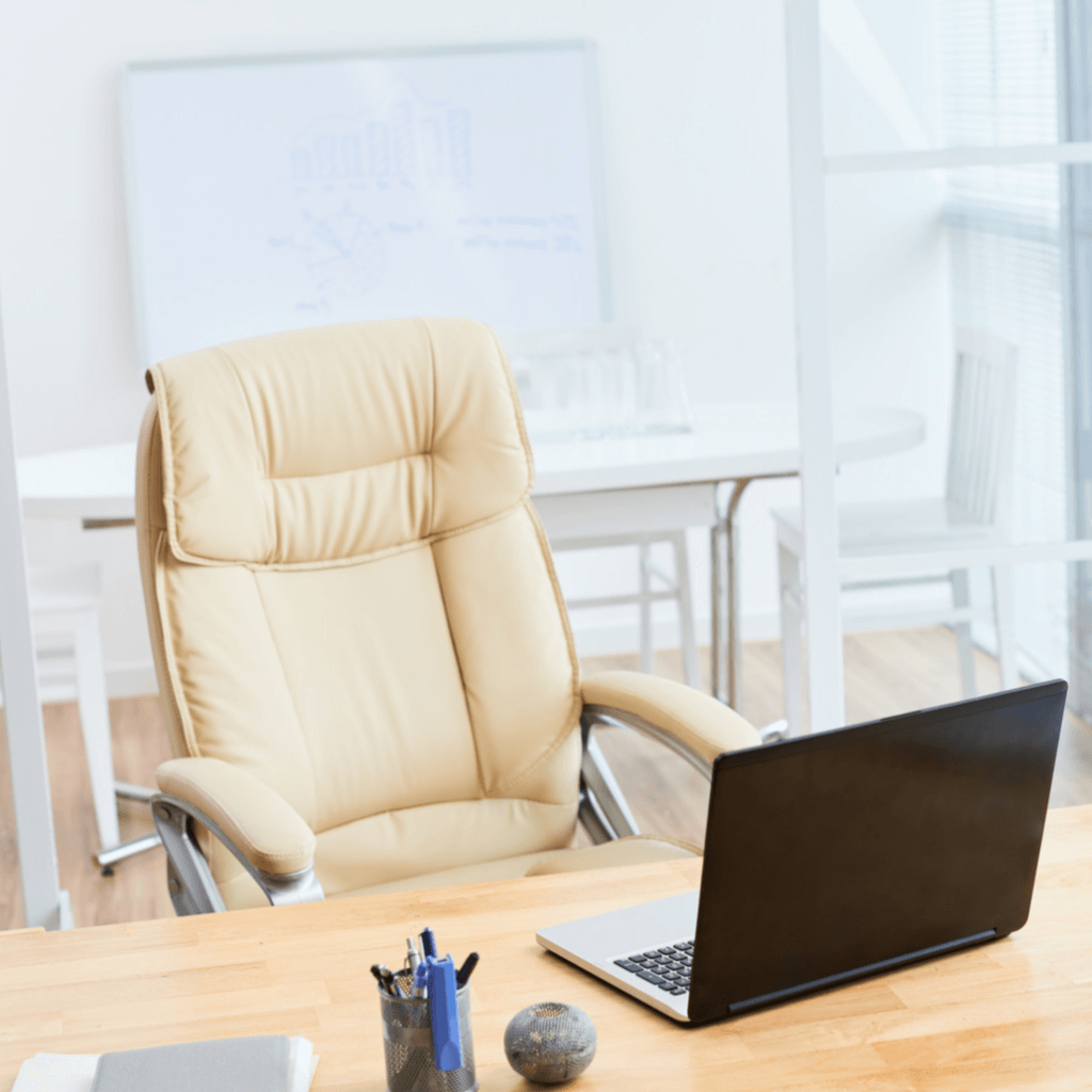 white office chair and a black laptop in an office setting